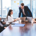 Corporate business team and manager in a meeting and advise idea to young officer