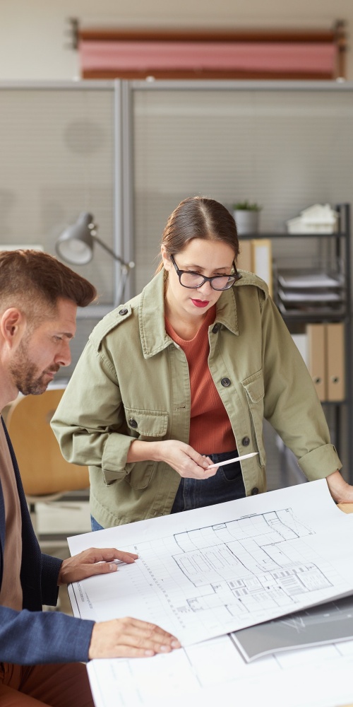 Two Architects Discussing Blueprints